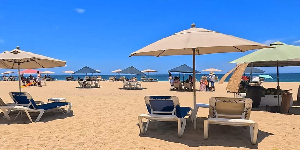 Zona de palapas San Pancho con servicios de sombrillas y restaurantes frente al mar.